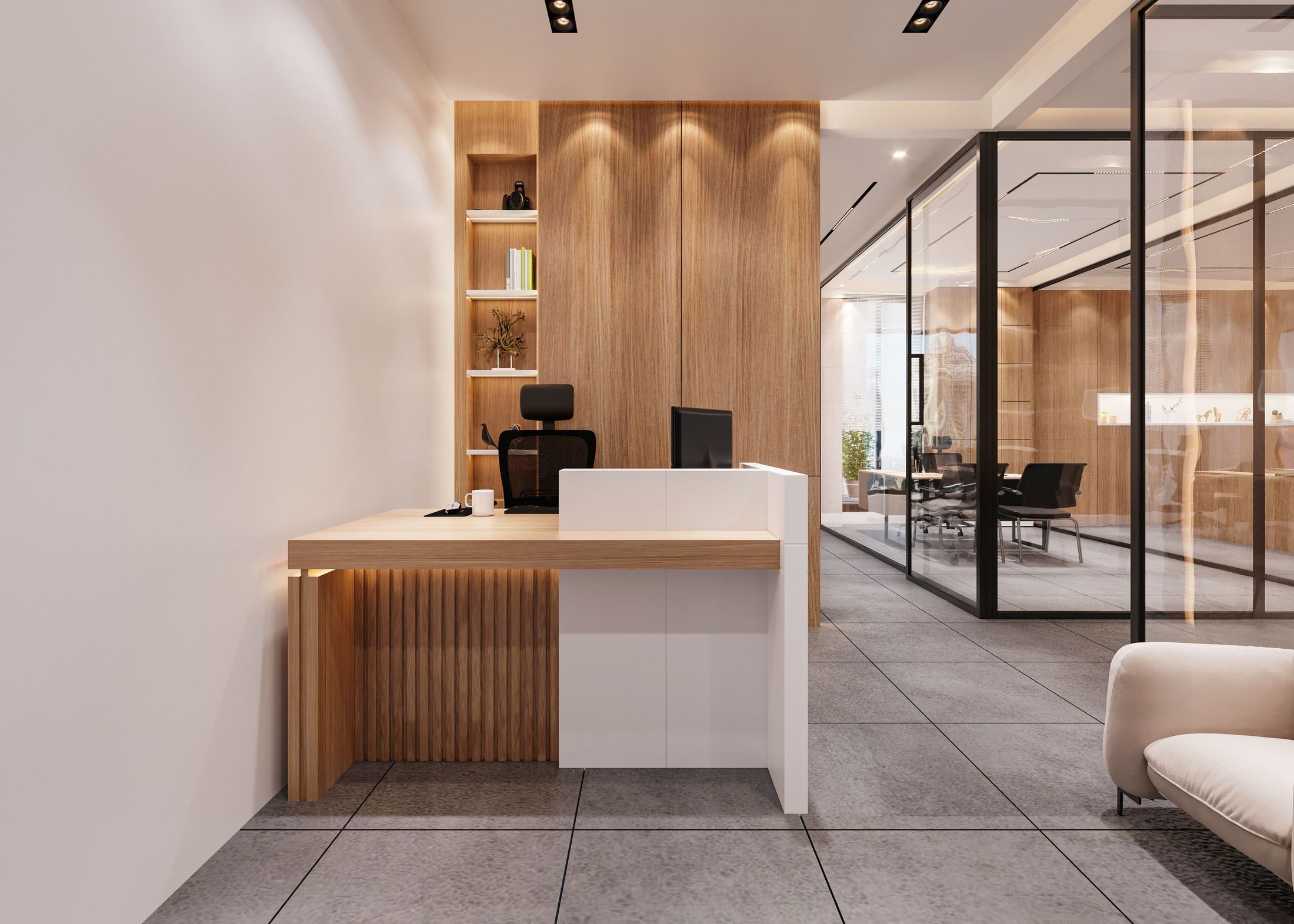 A serene, empty reception area with a wood-and-white desk and a glass-walled meeting room beyond.